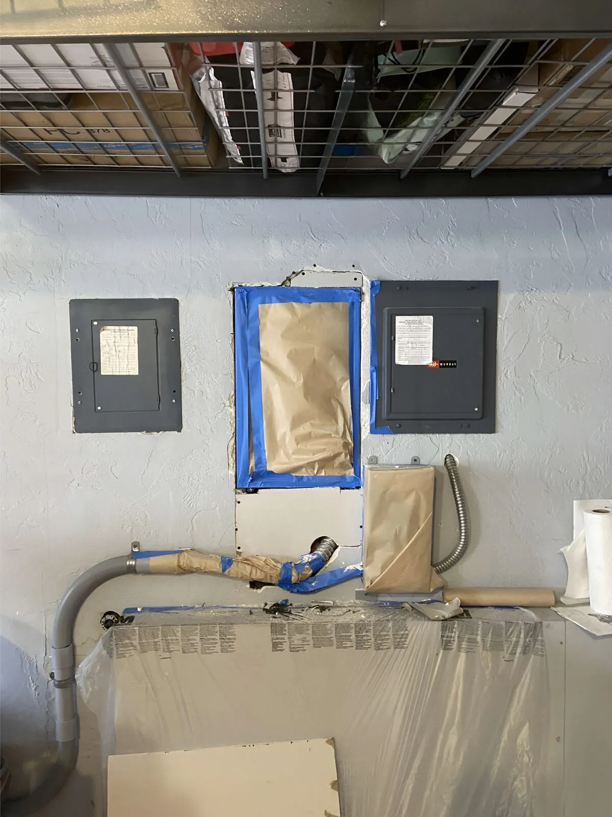 New drywall patch cut and installed around the electrical panel