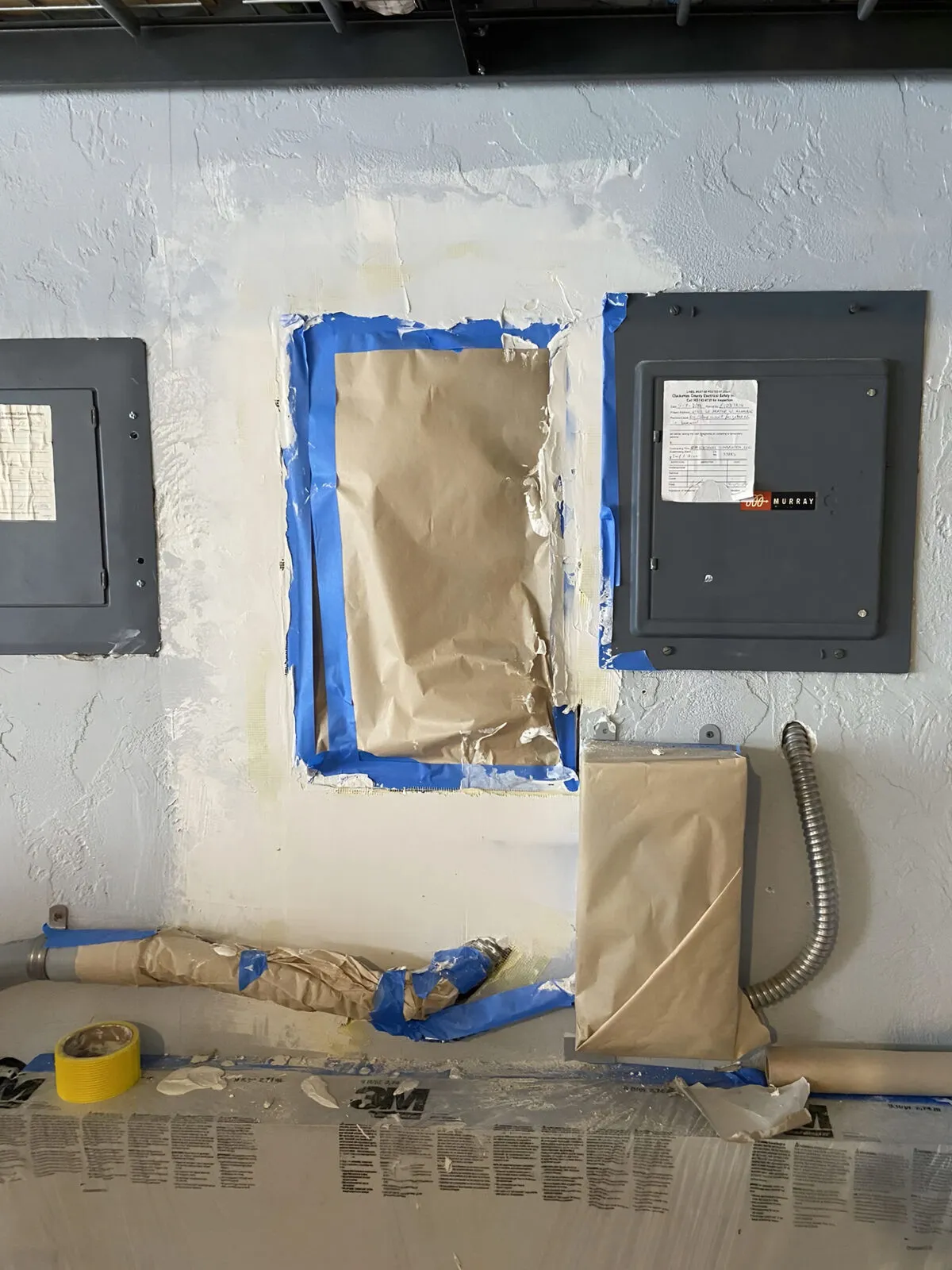 Joint compound being applied around the drywall patch to feather the seams