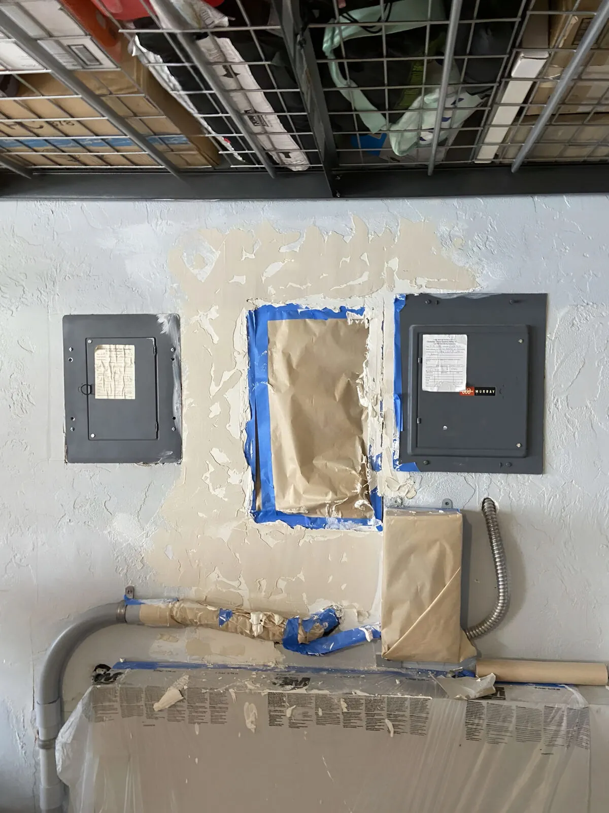 Hand-applied texture being matched to the existing wall around the electrical panel