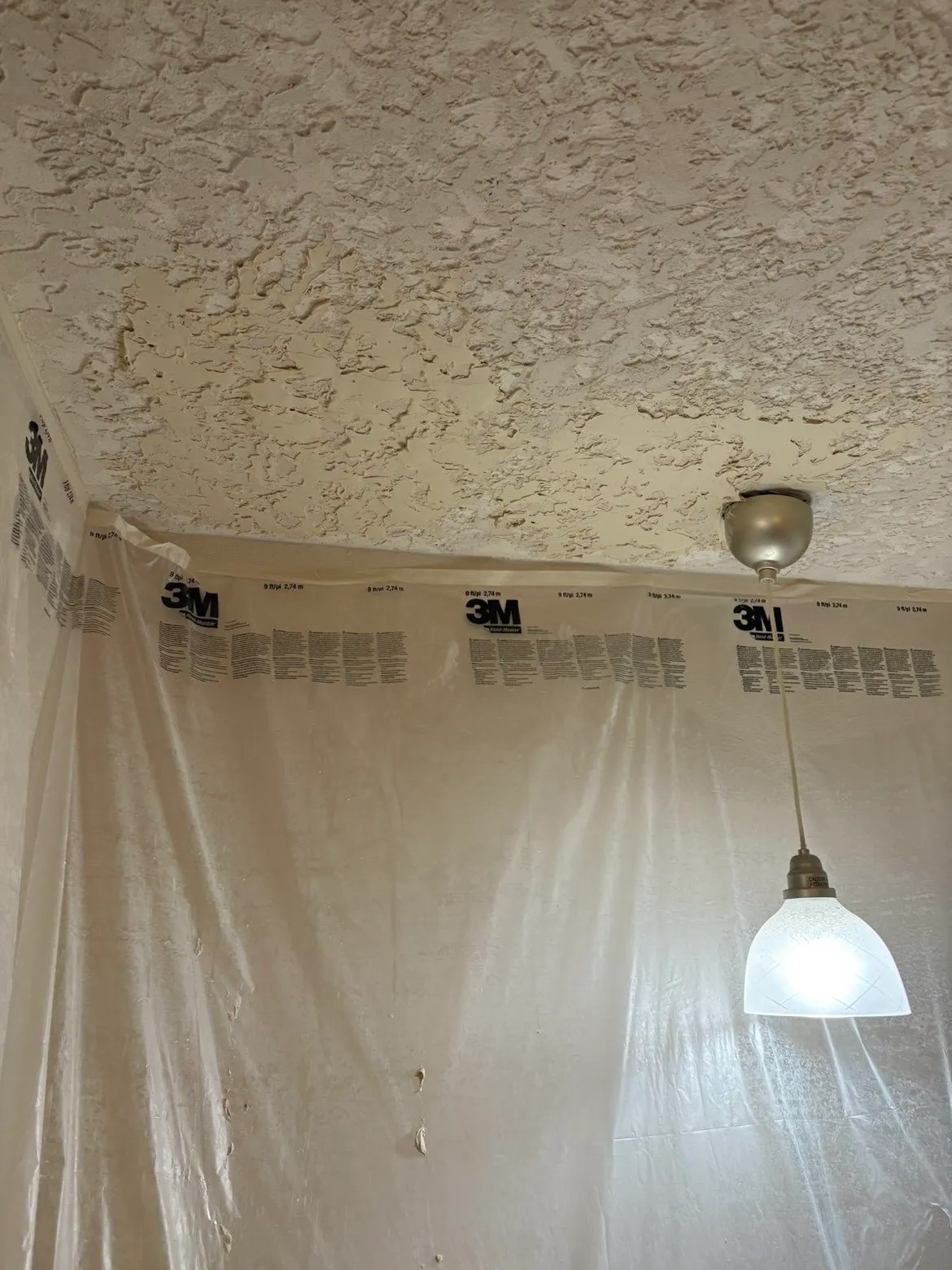 Finished kitchen ceiling with texture-matched patches blended into the existing ceiling
