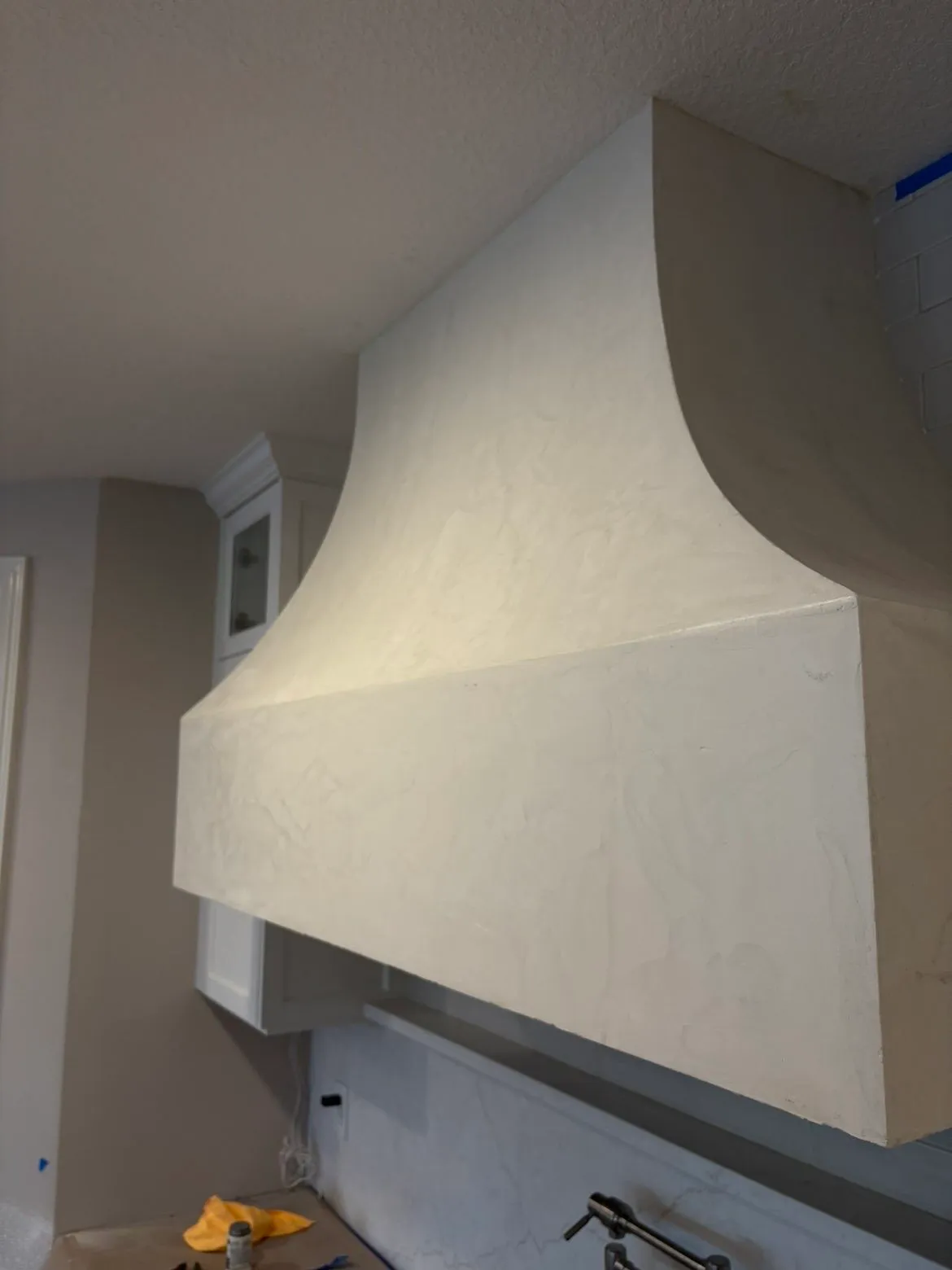 Close-up detail of Fresco Harmony texture on custom kitchen hood