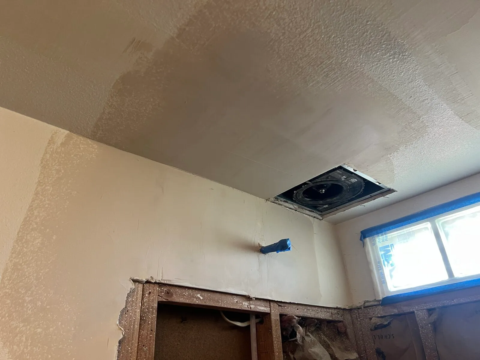Wall patches blended with mud in bathroom remodel