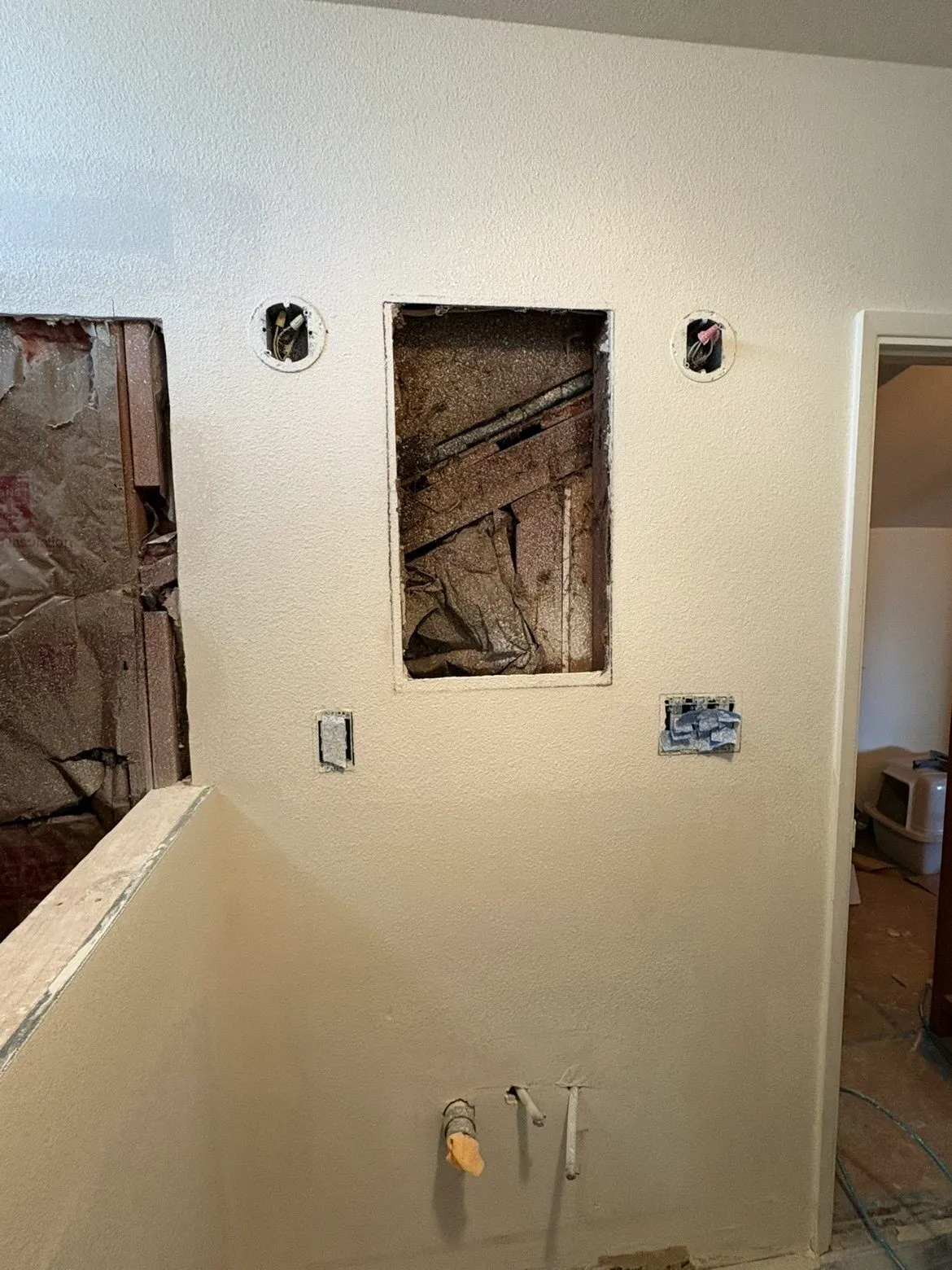 Bathroom wall patches with feathered mud blending into existing wall