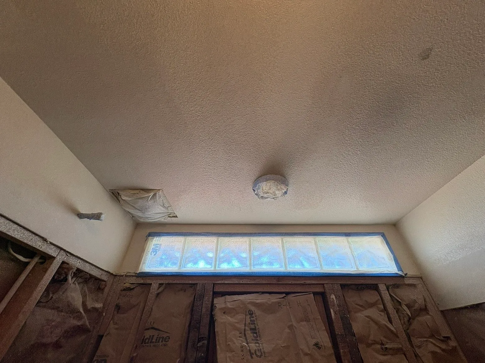 Bathroom ceiling patch work near vent and light fixture