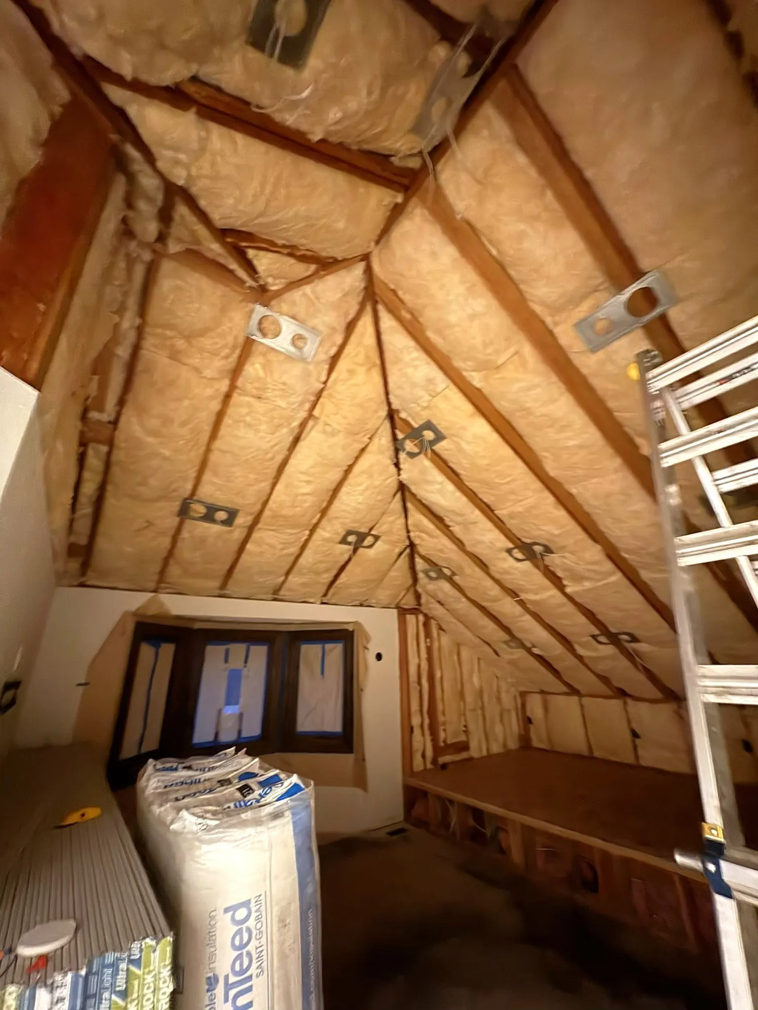 Attic batt insulation installation in vaulted ceiling of Clark County home