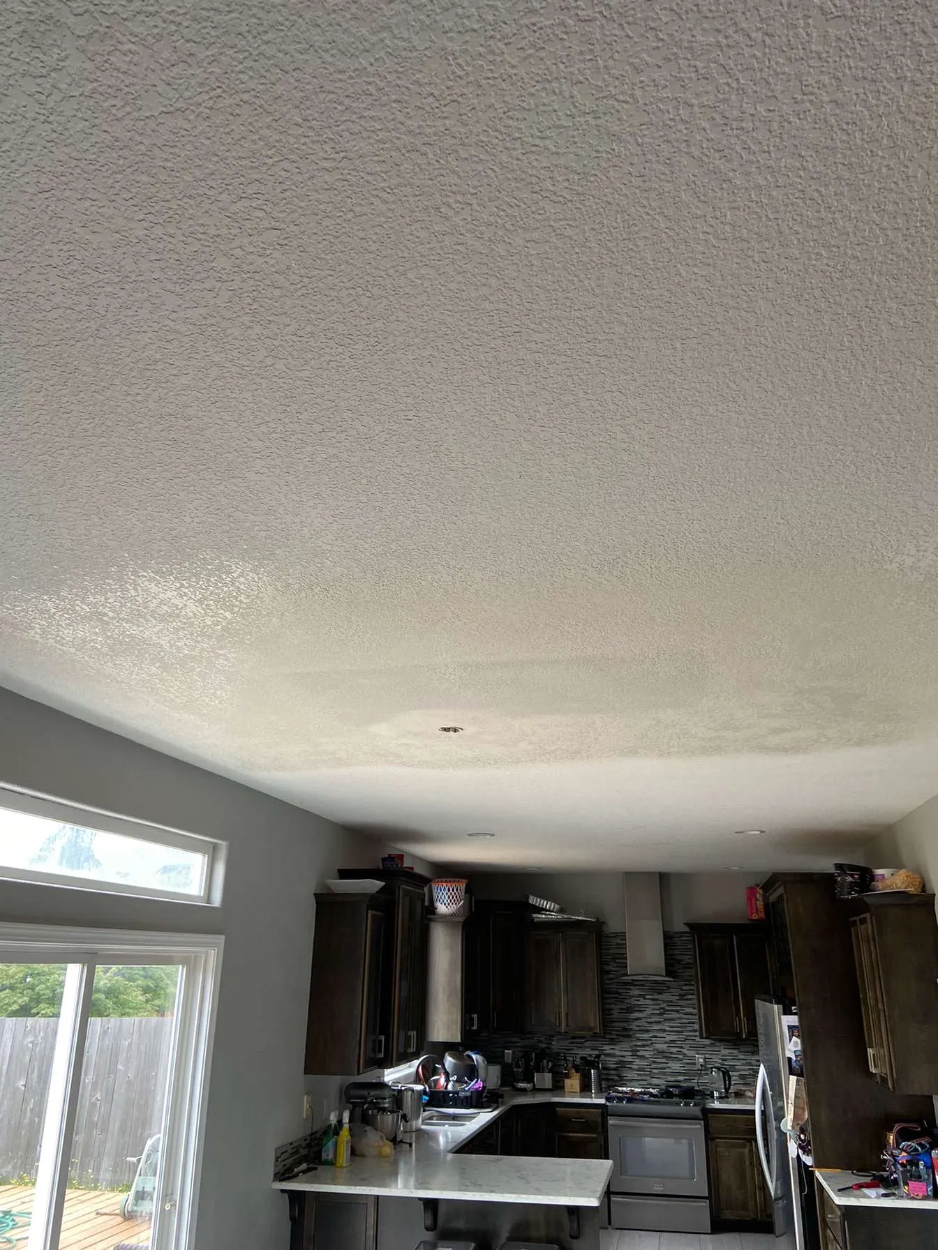 Drywall taping and mudding in new construction hallway