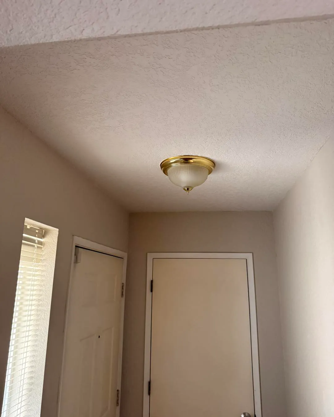 Hallway ceiling fully restored with matching texture and fresh paint
