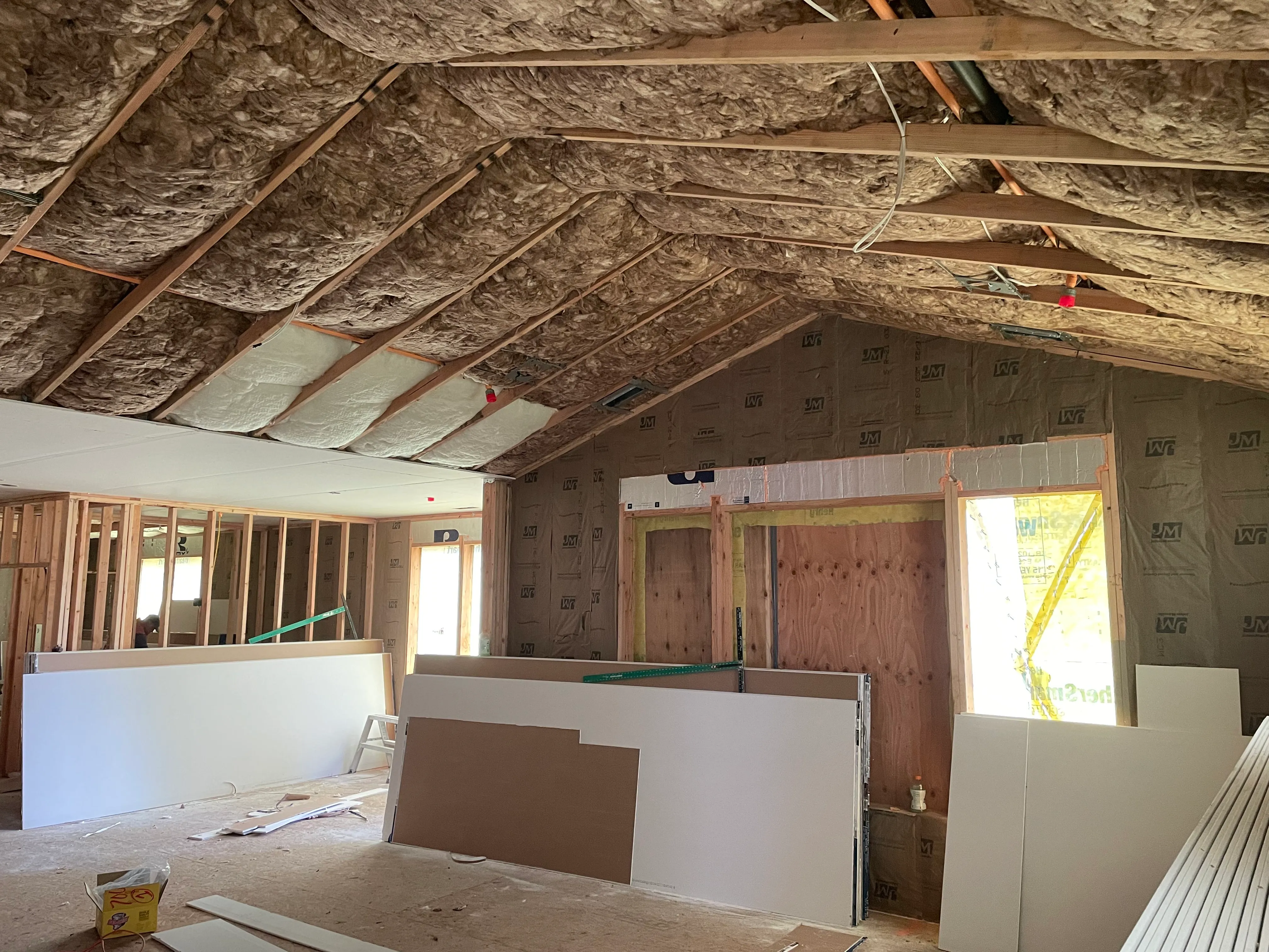 Insulation installation in corner and ceiling area of residential framing
