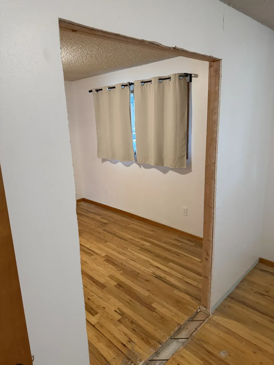 Original popcorn ceiling visible through an unfinished doorway in a Vancouver home