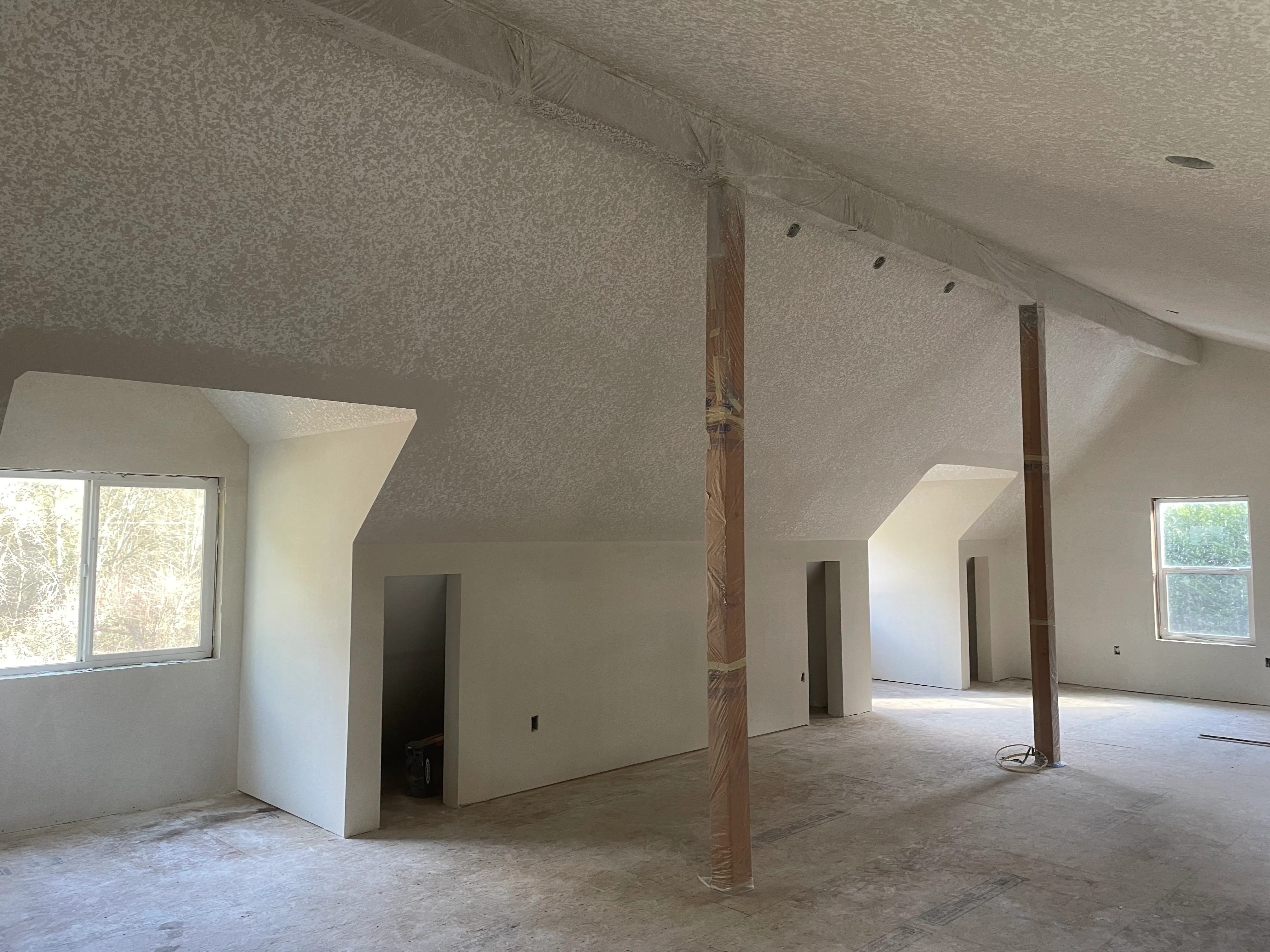 Textured vaulted ceiling in new construction room with natural light